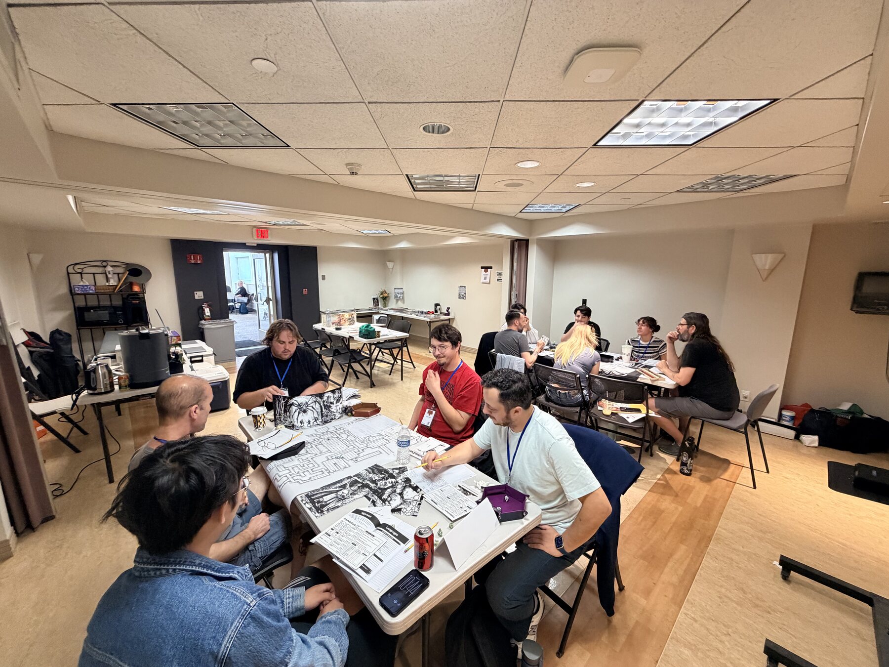Wide view of Mighty Deeds Summer 2026 gaming tables